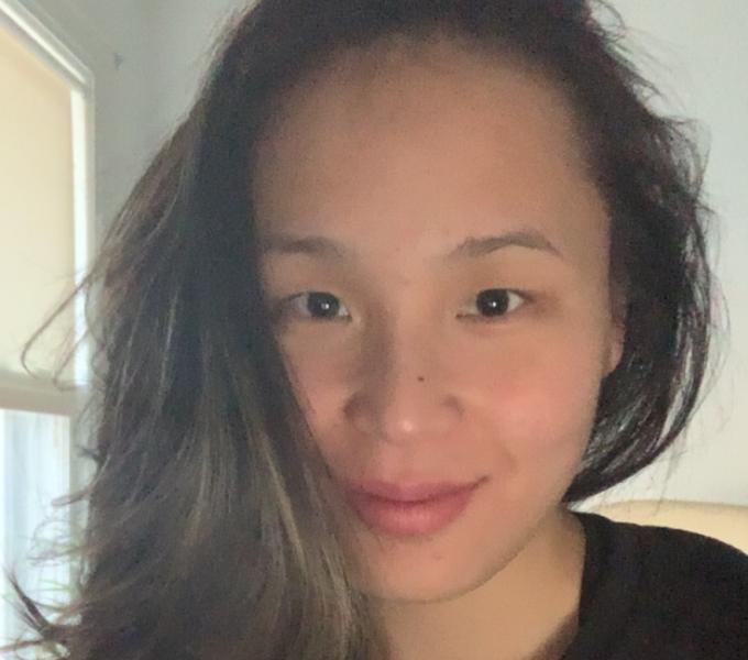 Photo of an individual with long dark hair. 